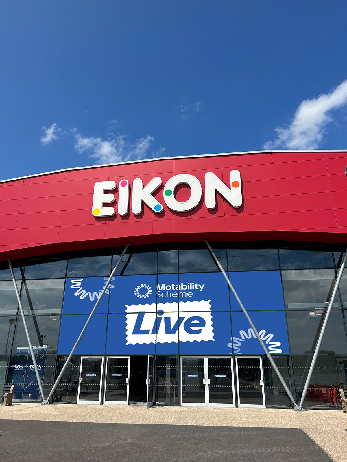 Exterior of EIKON building with Motability Scheme Live sign