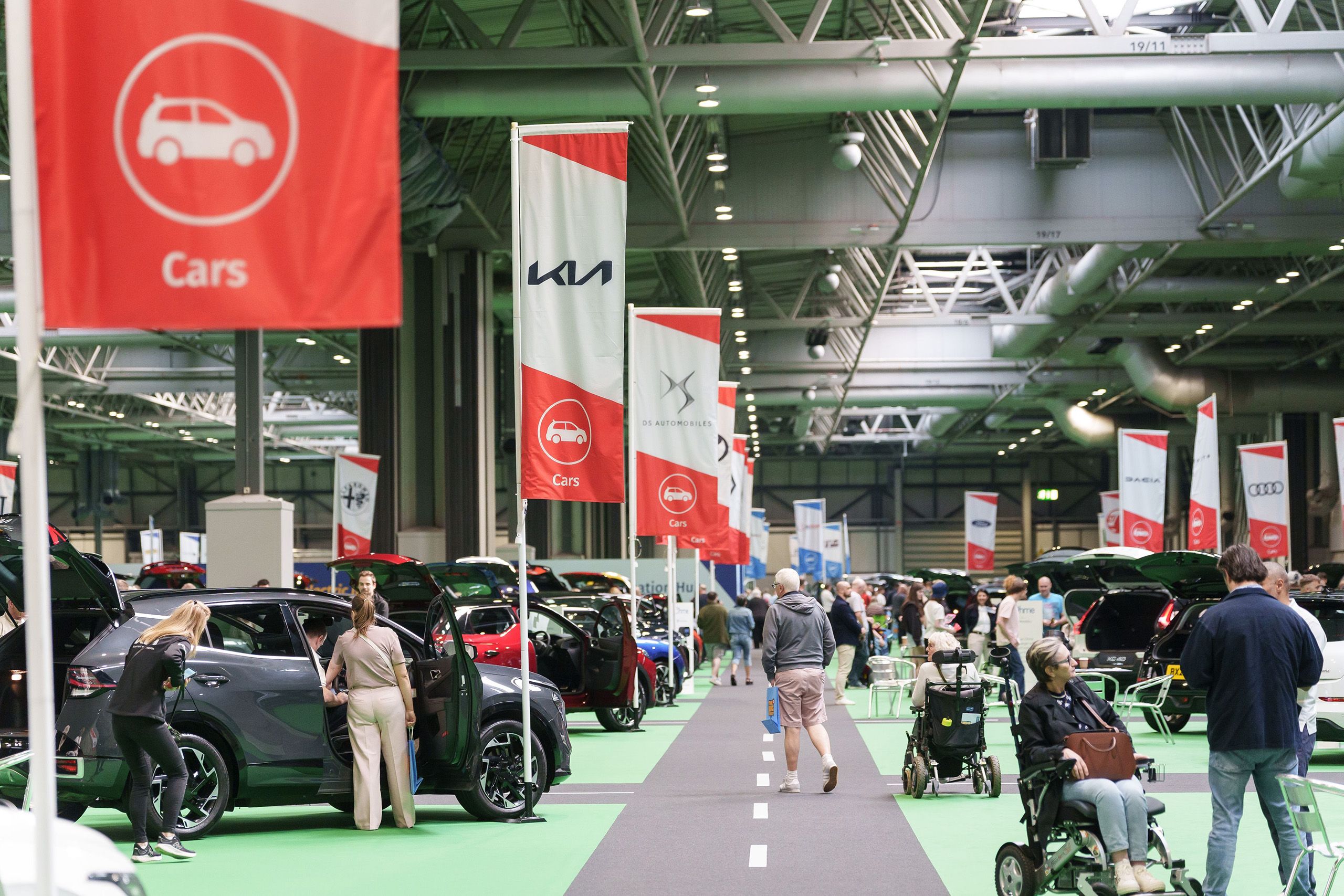 A car event hall with people and displays