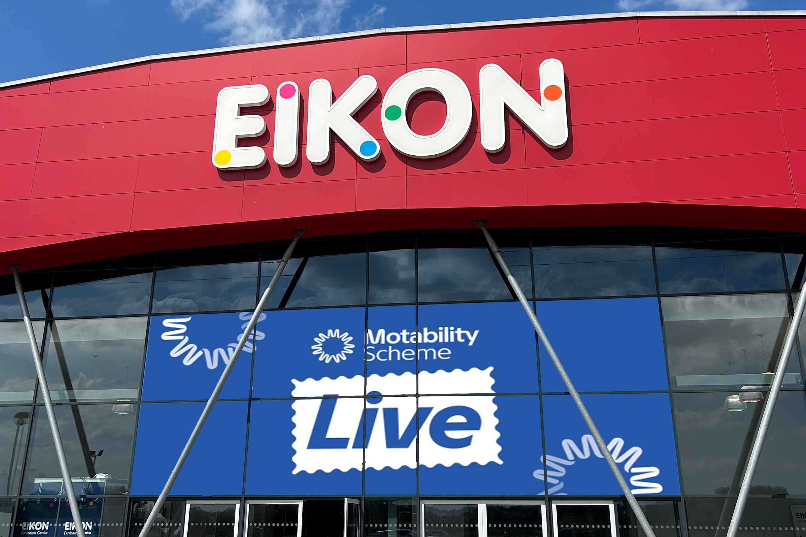 Exterior of EIKON building with Motability Scheme Live sign