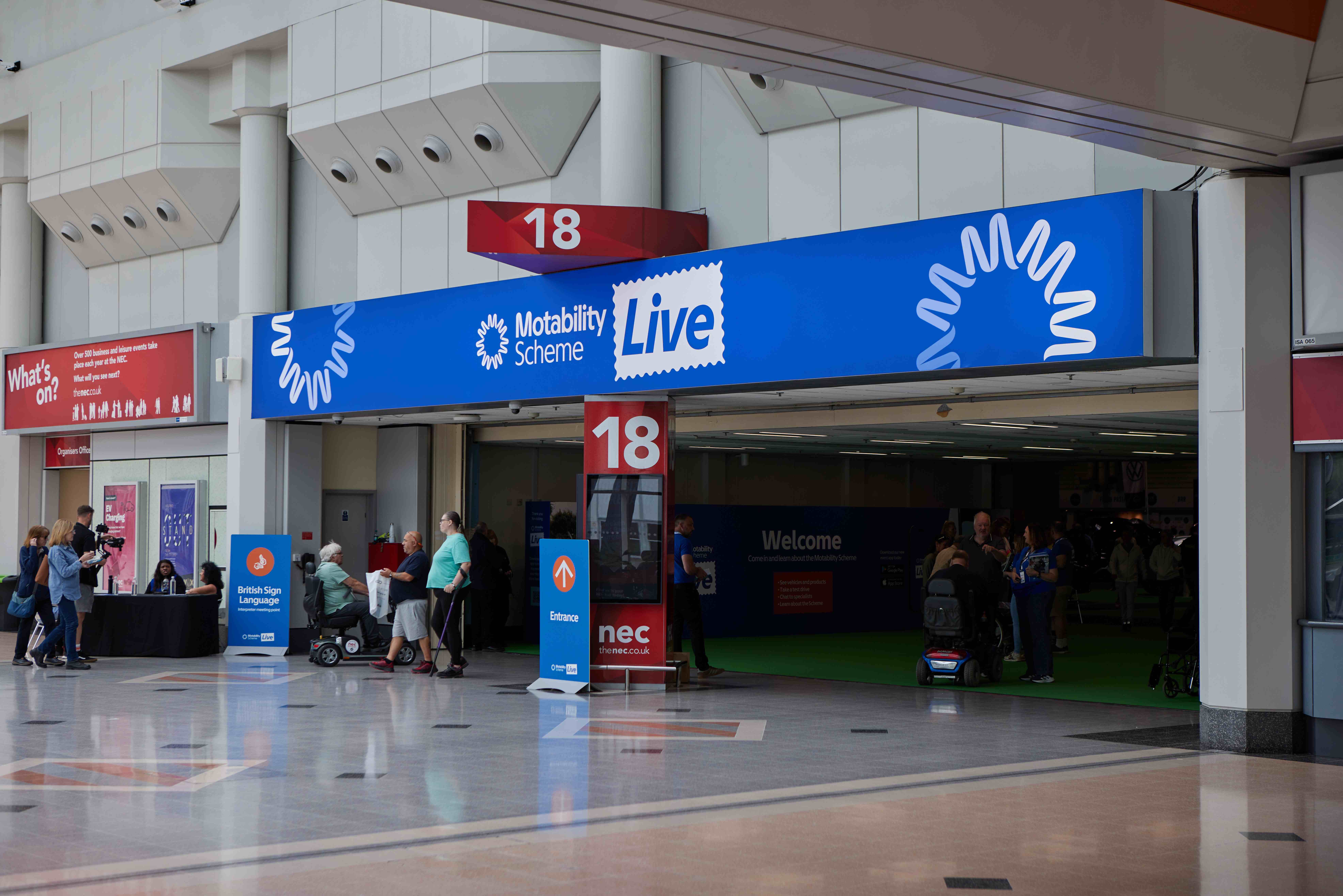 Visitors walking into hall 18 of the NEC
