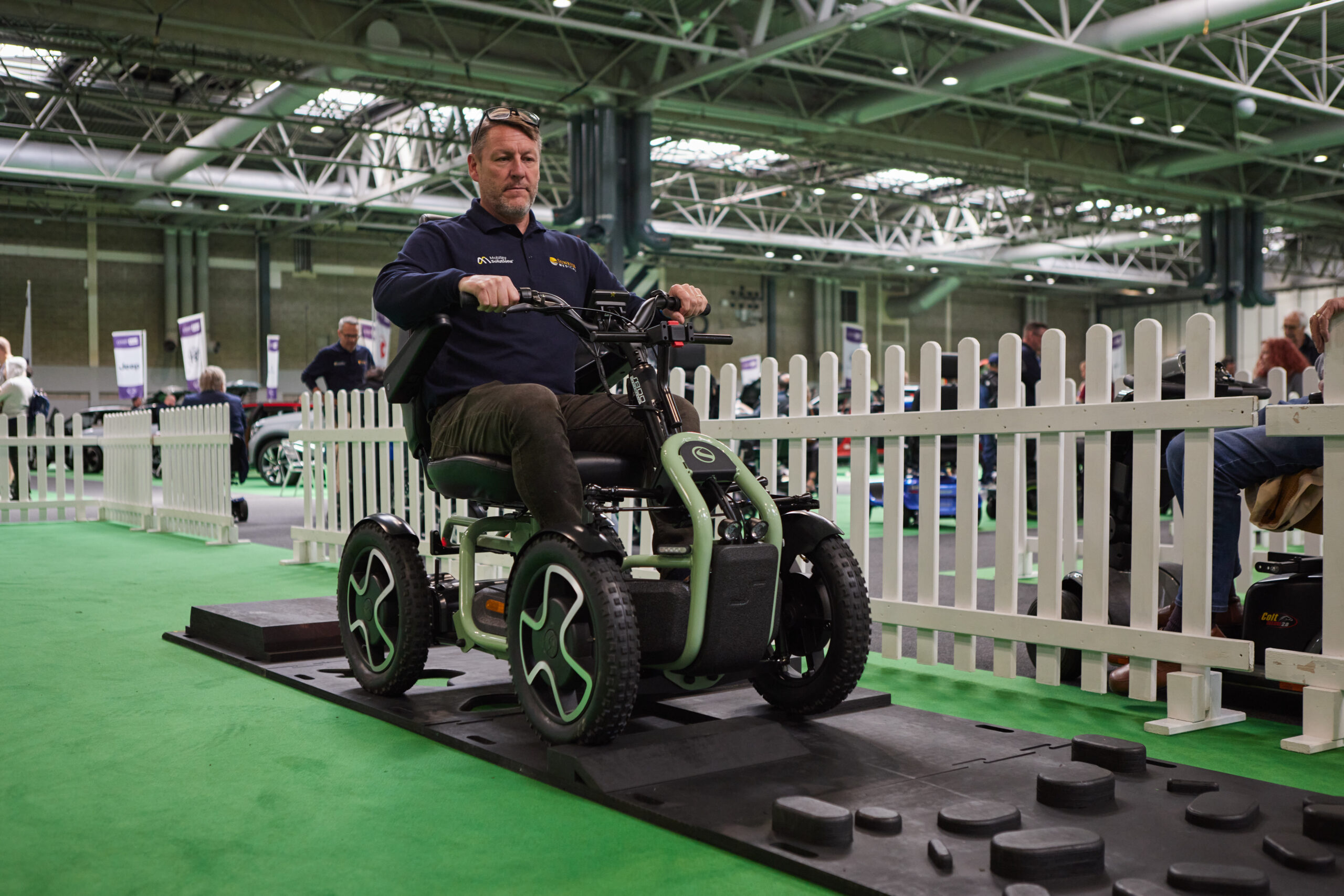 Someone using a powered scooter on a test track